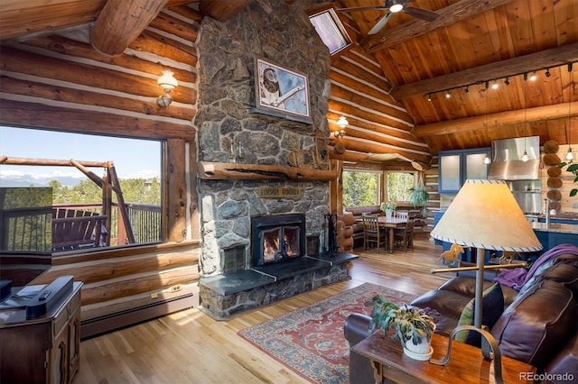 living room with a fireplace, beamed ceiling, hardwood / wood-style flooring, a baseboard heating unit, and wood ceiling