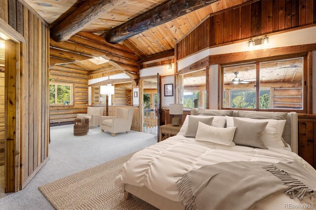 carpeted bedroom featuring lofted ceiling with beams and wooden ceiling