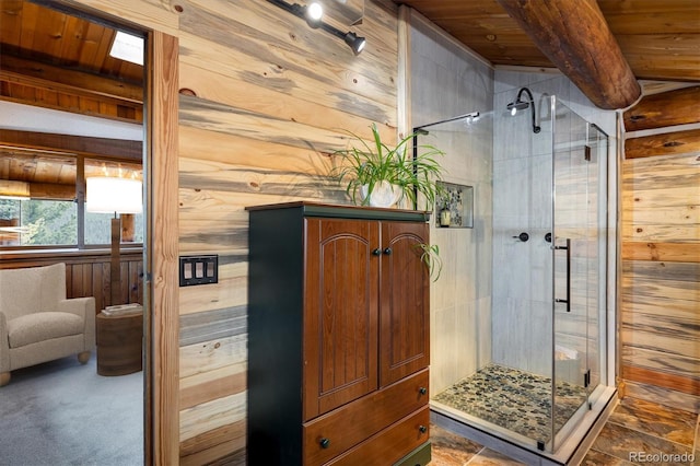 bathroom with an enclosed shower, wood ceiling, beam ceiling, and wooden walls