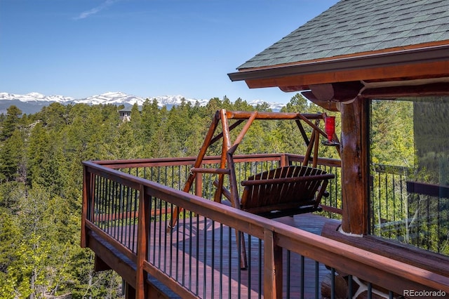 wooden deck with a mountain view