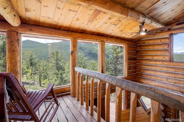 unfurnished sunroom featuring plenty of natural light and a mountain view