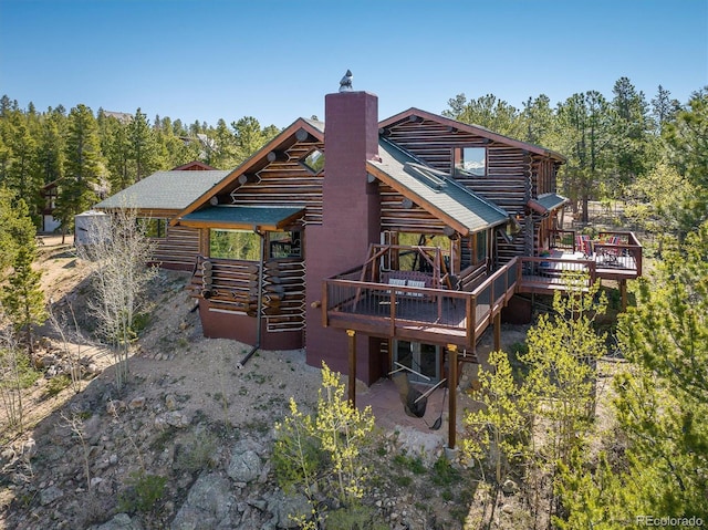 rear view of property with a wooden deck