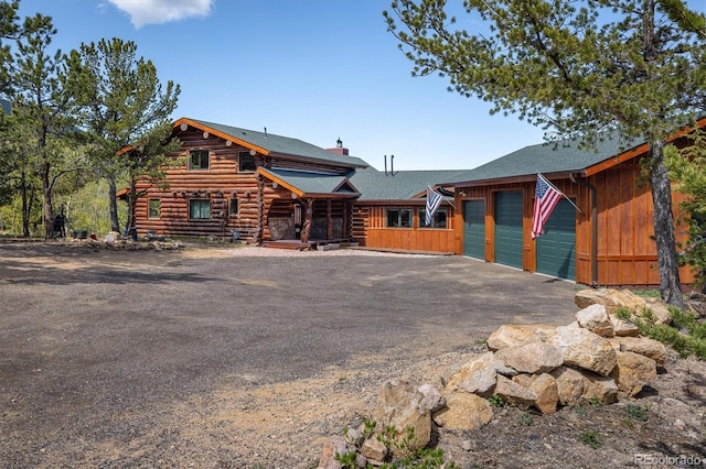 log home featuring a garage