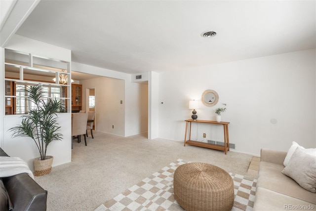 living room featuring carpet floors and visible vents