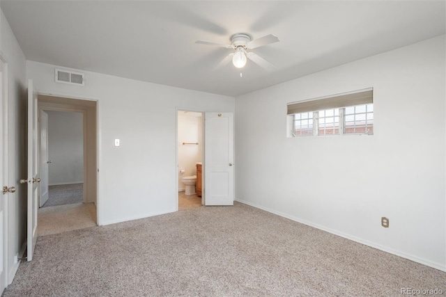 unfurnished bedroom featuring visible vents, baseboards, ensuite bath, and light colored carpet