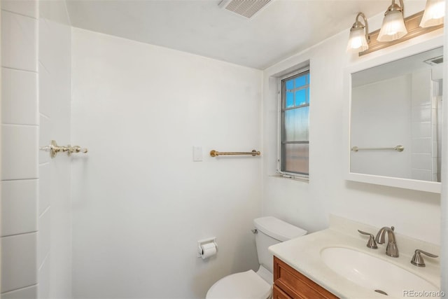 bathroom featuring toilet, visible vents, and vanity