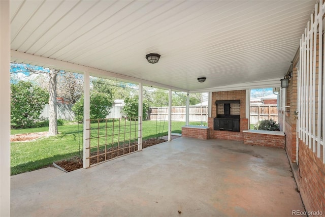 view of patio / terrace with a fenced backyard and a fireplace