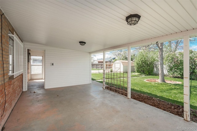 view of patio / terrace with a storage unit and an outdoor structure