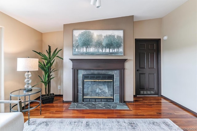 40192 Margaret Dr, Elizabeth, CO 80107 - living area featuring a tile fireplace, baseboards, wood finished floors, and lofted ceiling