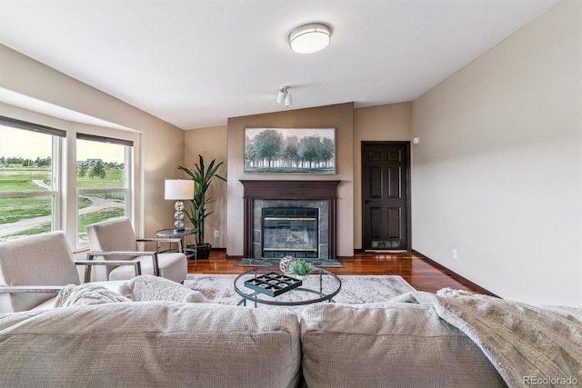 40192 Margaret Dr, Elizabeth, CO 80107 - living area with baseboards, wood finished floors, a fireplace, and lofted ceiling
