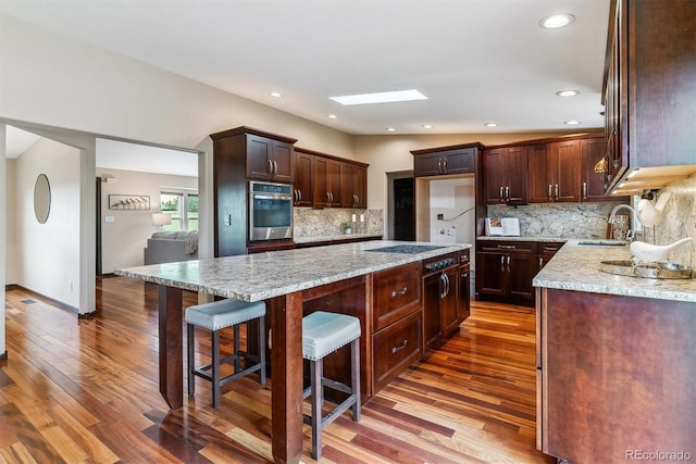 40192 Margaret Dr, Elizabeth, CO 80107 - kitchen with oven, dark wood-type flooring, light stone countertops, and a sink