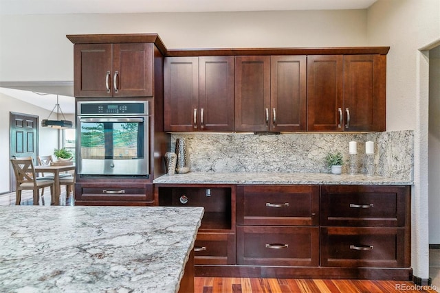 40192 Margaret Dr, Elizabeth, CO 80107 - bar featuring dark wood-style flooring, tasteful backsplash, and oven