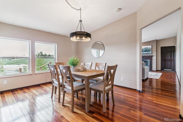 40192 Margaret Dr, Elizabeth, CO 80107 - dining space featuring a chandelier, hardwood / wood-style flooring, baseboards, and a fireplace