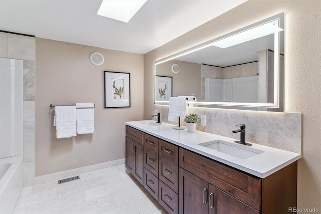 40192 Margaret Dr, Elizabeth, CO 80107 - full bath with baseboards, a skylight, visible vents, and a sink