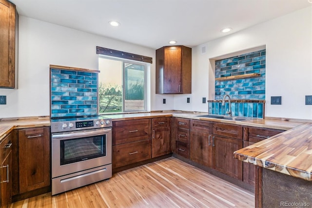 40192 Margaret Dr, Elizabeth, CO 80107 - kitchen with stainless steel range with electric stovetop, light wood-style floors, recessed lighting, and a sink