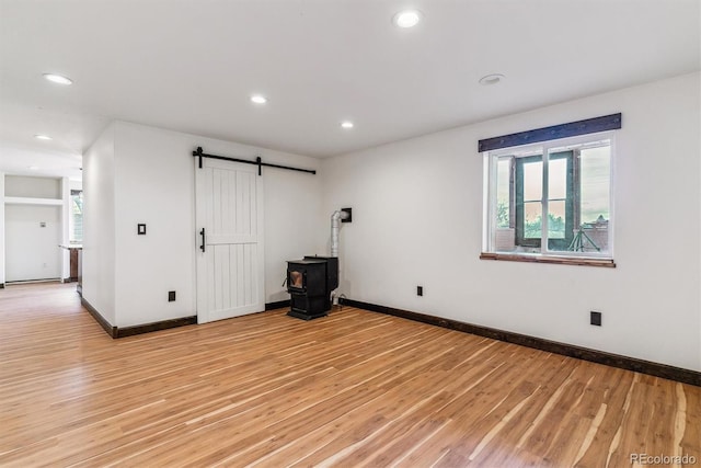 40192 Margaret Dr, Elizabeth, CO 80107 - spare room featuring light wood-style floors, a wood stove, recessed lighting, and plenty of natural light