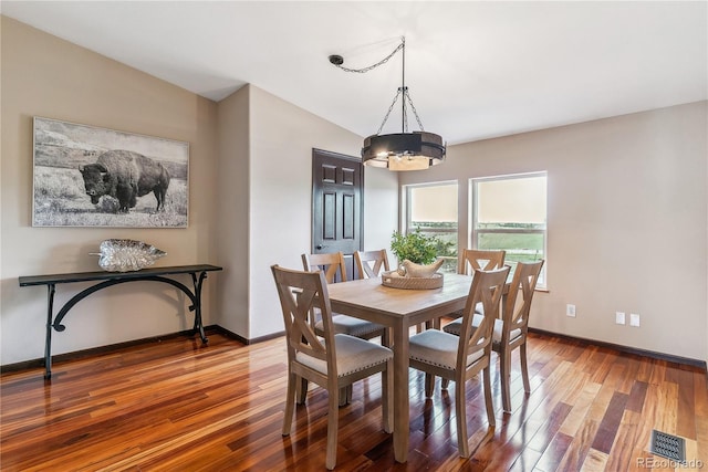 40192 Margaret Dr, Elizabeth, CO 80107 - dining area with a chandelier, wood finished floors, baseboards, and lofted ceiling