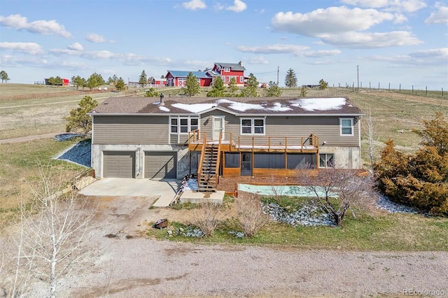 40192 Margaret Dr, Elizabeth, CO 80107 - view of front of house with a deck, stairway, driveway, and an attached garage