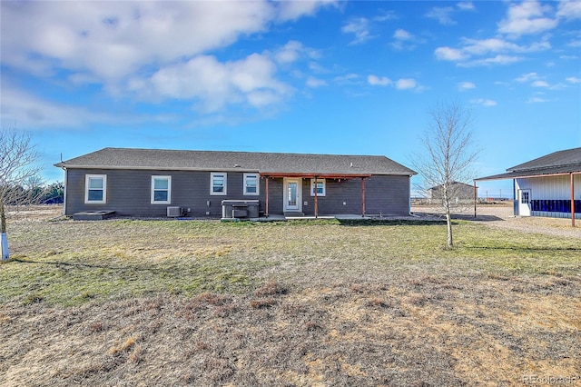 ranch-style house with central AC and a front lawn