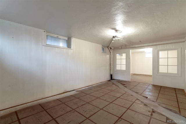 1335 Locust St, Denver, CO 80220 - empty room with a textured ceiling, plenty of natural light, and light floors