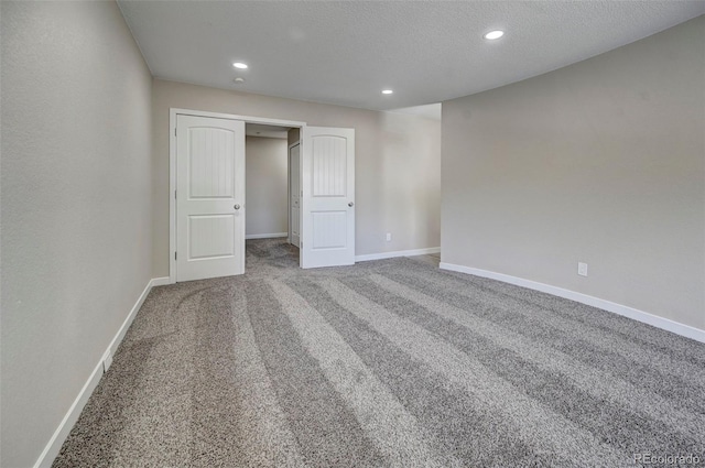 unfurnished bedroom with carpet floors and a textured ceiling