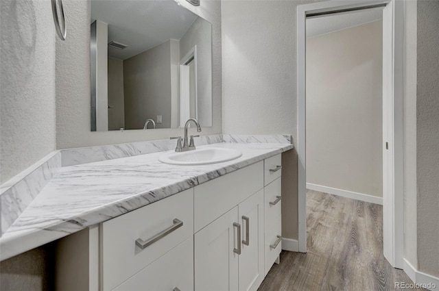 bathroom with wood-type flooring and vanity