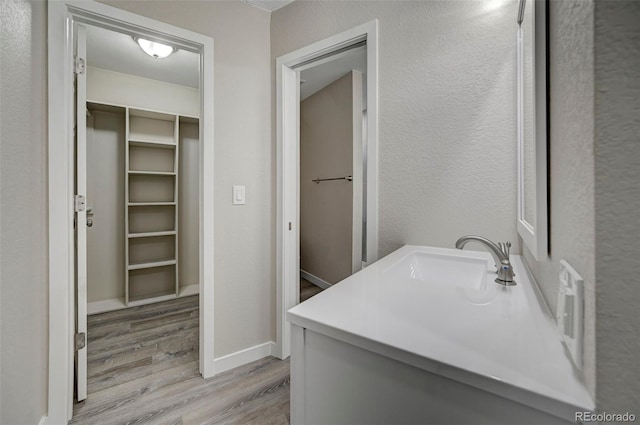 bathroom with vanity and hardwood / wood-style floors