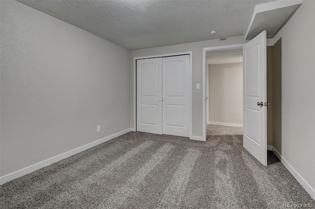 unfurnished bedroom featuring carpet floors, a closet, and a textured ceiling