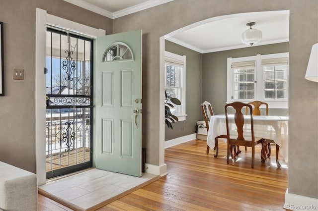 foyer featuring crown molding and hardwood / wood-style floors