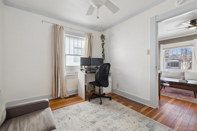 office area featuring ceiling fan, crown molding, wood-type flooring, and a healthy amount of sunlight