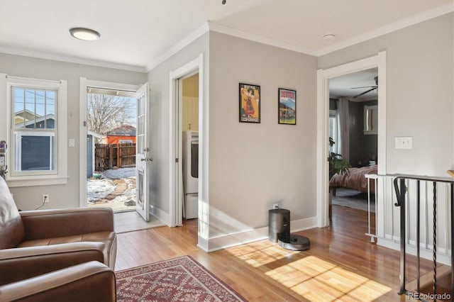 sitting room featuring crown molding and light hardwood / wood-style floors