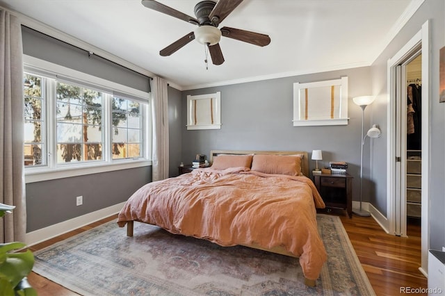 bedroom featuring dark wood-type flooring, ceiling fan, and crown molding