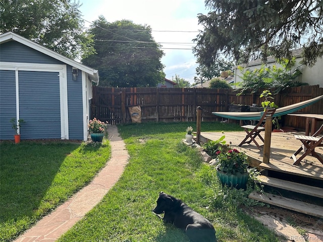 view of yard featuring a wooden deck and an outbuilding