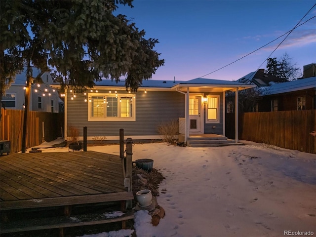 bungalow with a deck and fence