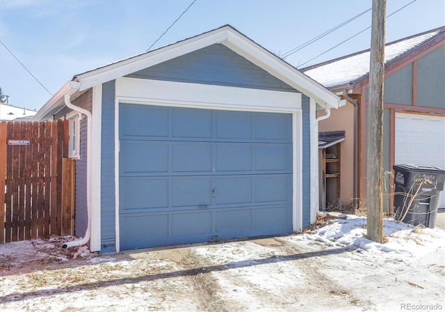 detached garage featuring fence