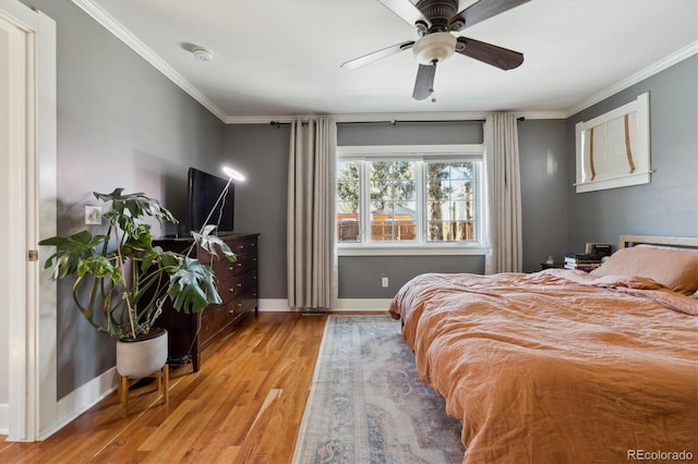 bedroom featuring baseboards, wood finished floors, ornamental molding, and a ceiling fan