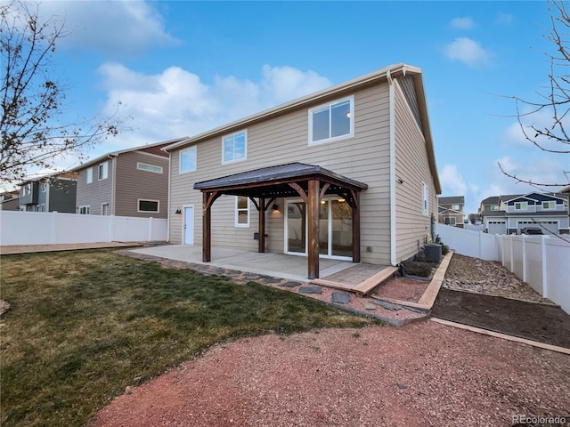 rear view of property with a yard, a patio, a gazebo, a residential view, and a fenced backyard