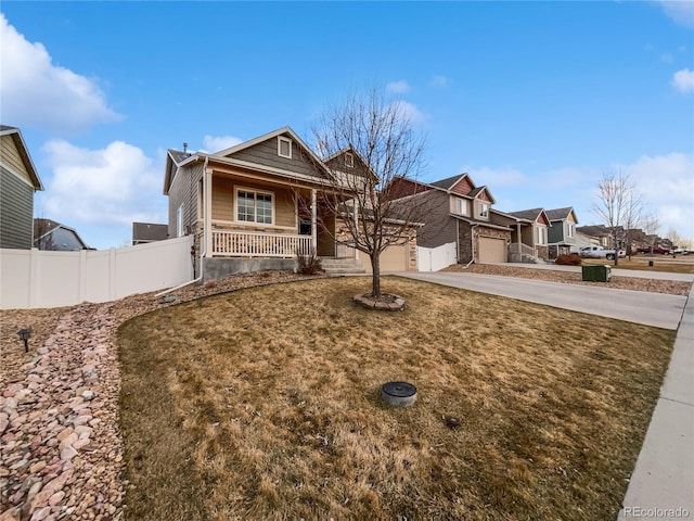 view of front of property featuring a porch, concrete driveway, fence, a garage, and a residential view