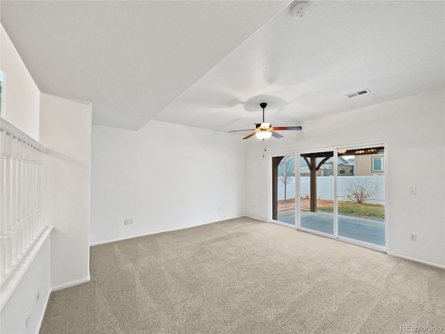 spare room featuring baseboards, carpet, visible vents, and a ceiling fan