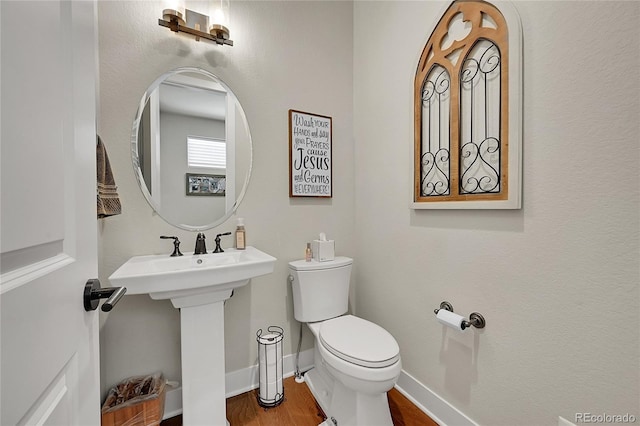 bathroom featuring sink, toilet, and hardwood / wood-style flooring