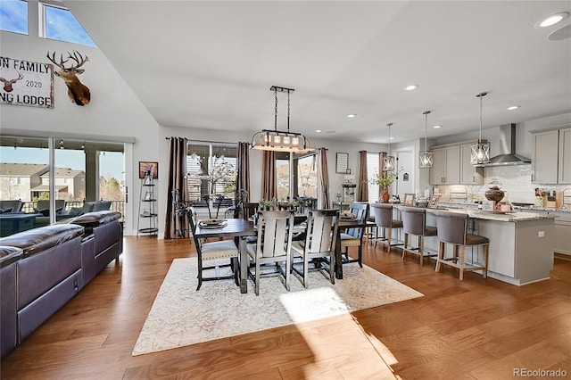 dining space with light wood-type flooring and plenty of natural light