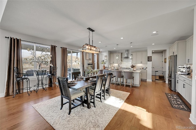 dining space with light hardwood / wood-style flooring