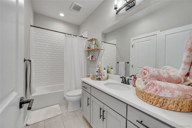 full bathroom with tile patterned floors, toilet, shower / bathtub combination with curtain, and vanity