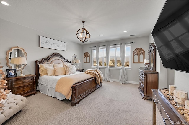 carpeted bedroom featuring an inviting chandelier