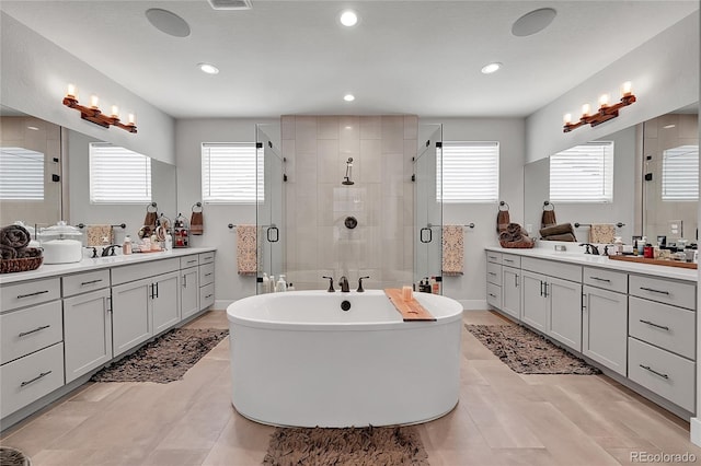 bathroom featuring vanity, plenty of natural light, and separate shower and tub