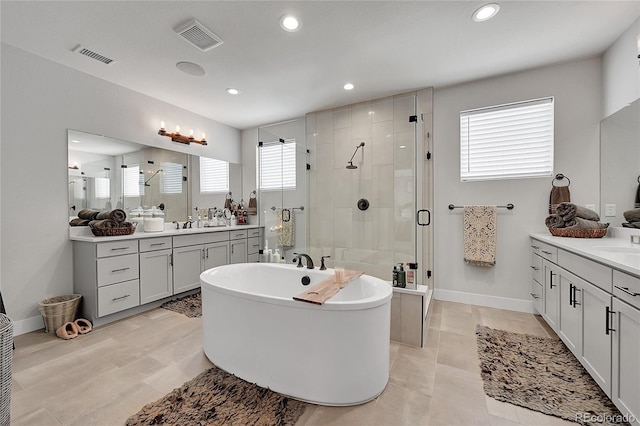 bathroom with tile patterned flooring, vanity, and shower with separate bathtub