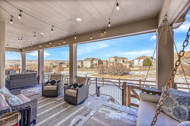 snow covered deck with an outdoor living space