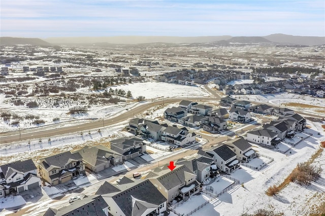 snowy aerial view with a mountain view