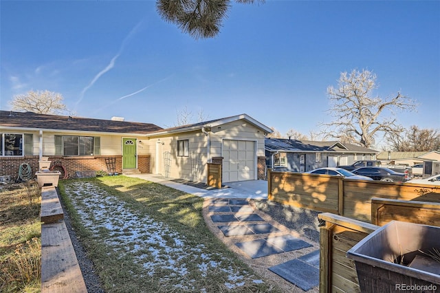 back of house with a yard and a garage