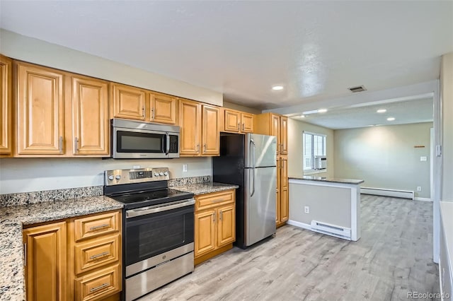 kitchen featuring appliances with stainless steel finishes, light hardwood / wood-style floors, light stone counters, and a baseboard heating unit